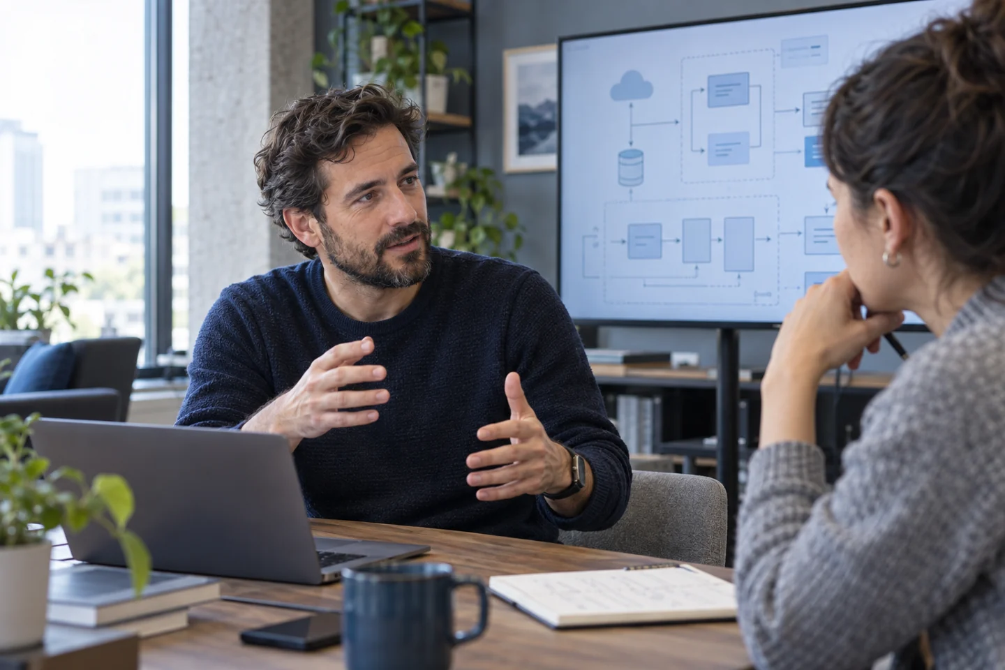 Technical specialist discussing system architecture with a colleague